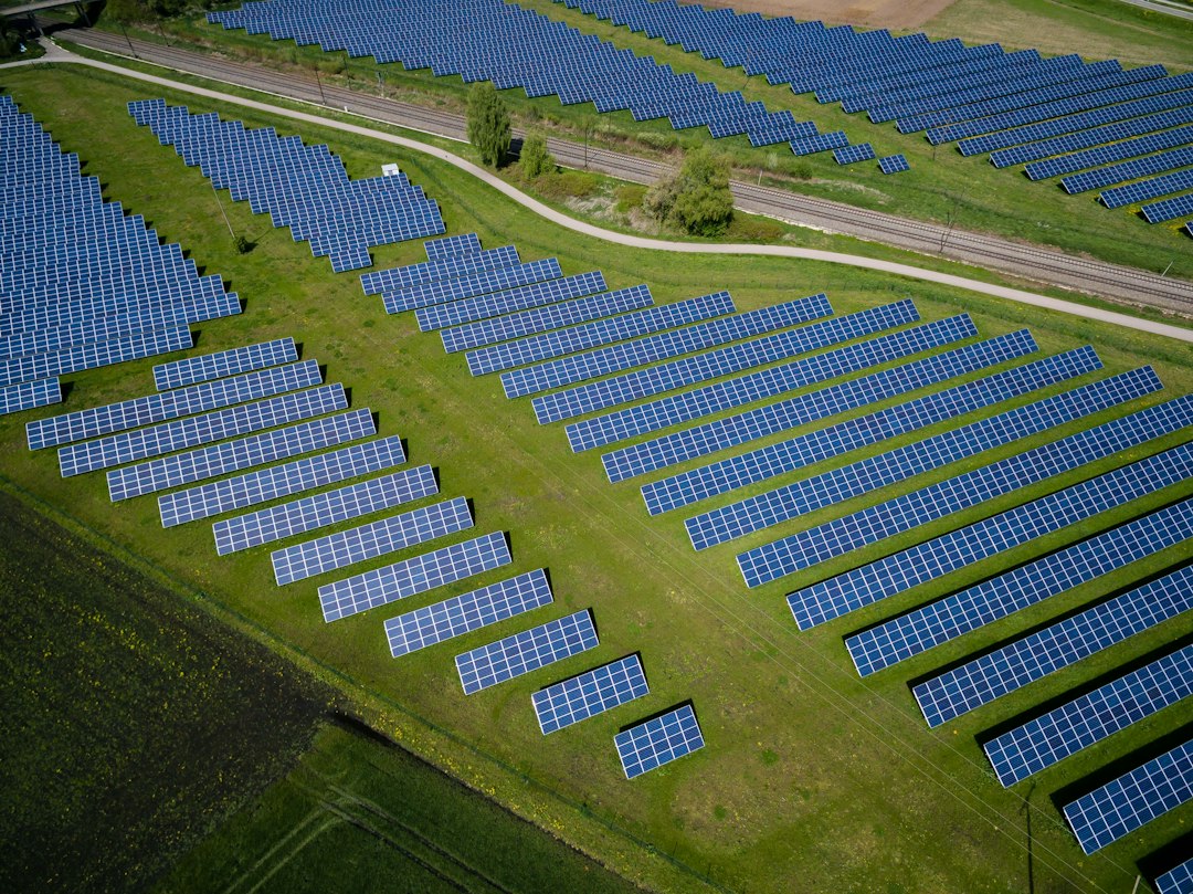 Aerial view of a utility-scale solar photovoltaic field with long rows of panels